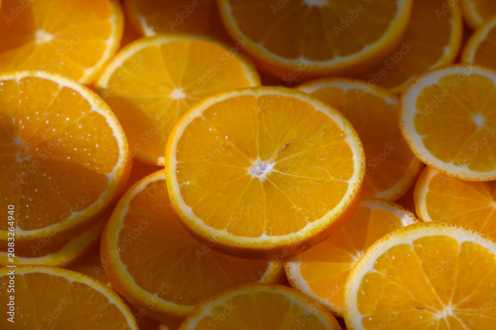 Fototapeta premium Brightly sliced oranges create a vibrant display in a sunny marketplace