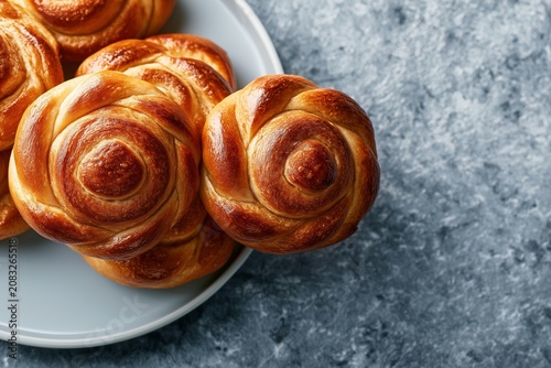 Golden Baked Swirl Buns Freshly Prepared on a Plate Close Up