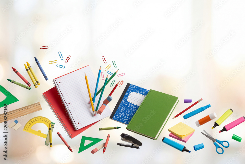 Fototapeta premium School supplies are spread out on a surface with bright colors and various tools for writing and drawing