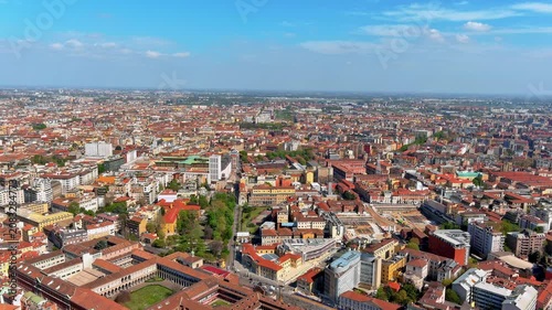 Aerial drone panorama of Milan's dense cityscape with the Ca' Granda University of Milan courtyards in the foreground, Lombardy, Italy, spring daytime.