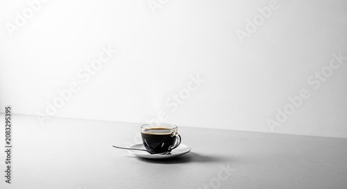 Minimalist espresso cup on white table with soft lighting.