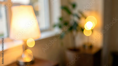 Table lamp with green plant in a soft dreamy out of focus a sunlit reading nook