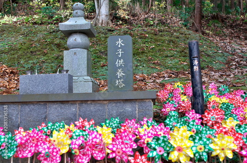 Nov 11, 2018, Aomori, Japan: A stone memorial tower for aborted fetuses Mizuko Kuyo To surrounded by colorful plastic toy pinwheels at Seiryu-ji Temple
