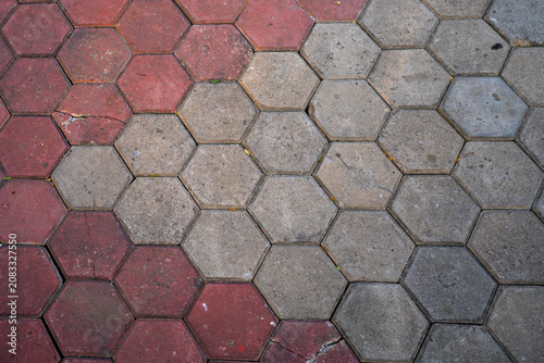 Red and grey hexagonal paving block tiles pattern on outdoor pedestrian sidewalk floor background