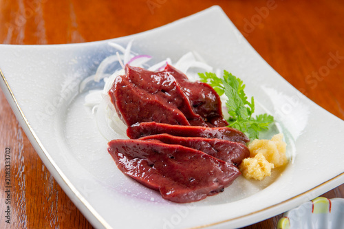 Obraz na plátne Fresh sliced beef liver sashimi elegantly plated with wasabi and grated daikon