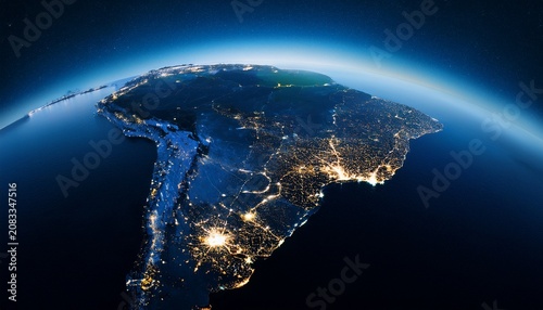 earth view from space showing south america at night with city lights illuminating the continent aerial perspective