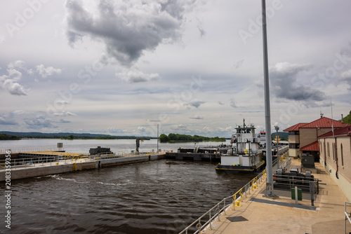 A barge with a load of oil passing through a lock and dam on the Mississippi River.