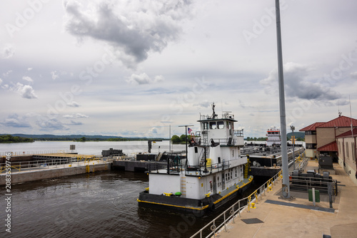 A barge with a load of oil passing through a lock and dam on the Mississippi River.