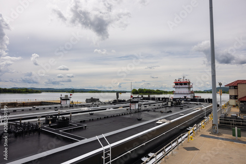 A barge with a load of oil passing through a lock and dam on the Mississippi River.