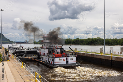 A barge with a load of oil passing through a lock and dam on the Mississippi River.