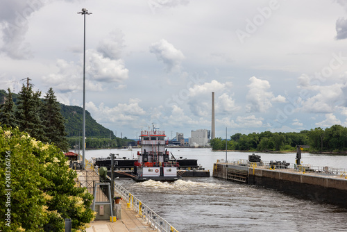 A barge with a load of oil passing through a lock and dam on the Mississippi River.