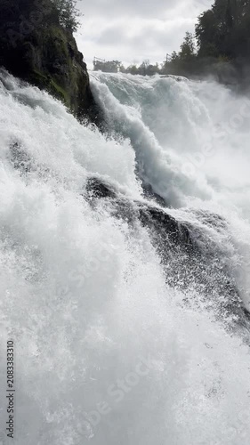 Schaffhausen, Switzerland - October 11, 2025: View of the Rhine Falls, Europe’s largest waterfall, with powerful cascades and the surrounding landscape on an autumn day.
