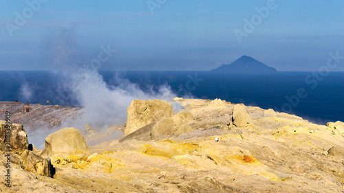 Volcanic fumaroles with sulfur deposits on Vulcano island with Filicudi in the background, Italy