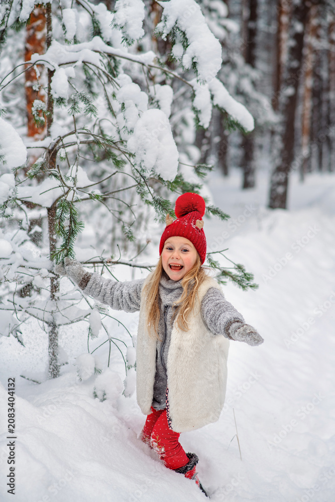 Fototapeta premium A girl laughs in the forest in winter