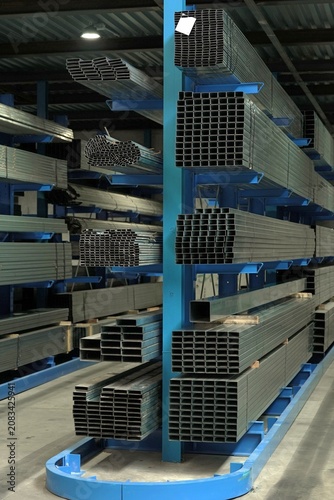 Industrial metal warehouse. Organized steel sections on cantilever racks. Industrial metal storage racks.