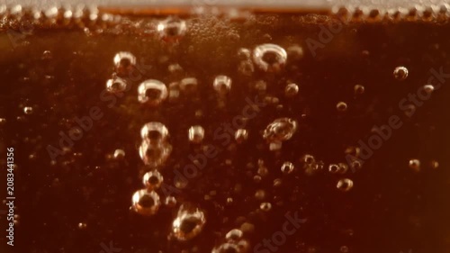 Ultra realistic cinematic footage of beverage bubbles rising in liquid, macro close-up, no people, 4K UHD