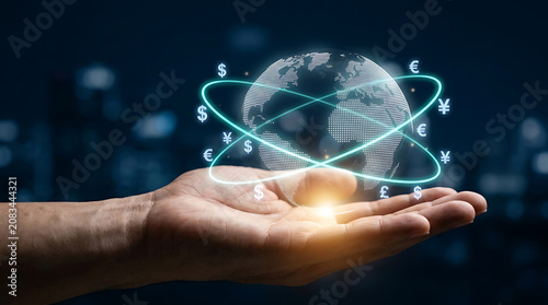 Holding a digital globe with currency symbols in a futuristic business setting