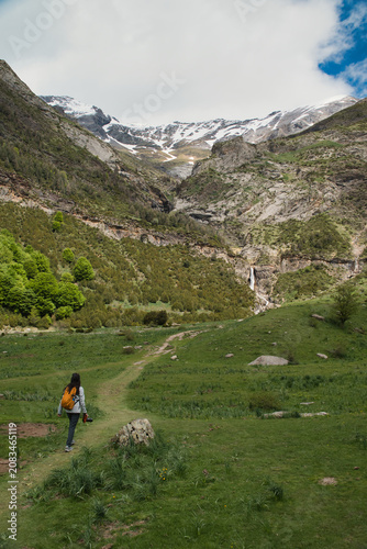 A young girl hiking alone in the Pyrenees, Pineta Valley, Monte Perdido, Camino de los Llanos de la Larri, Aragón, Huesca, Spain