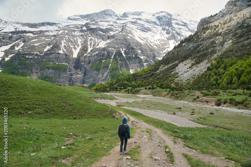 A young girl hiking alone in the Pyrenees, Pineta Valley, Monte Perdido, Camino de los Llanos de la Larri, Aragón, Huesca, Spain