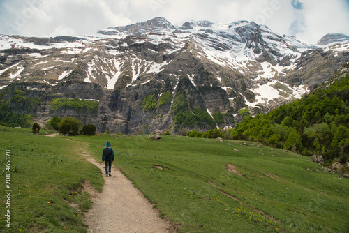 A young girl hiking alone in the Pyrenees, Pineta Valley, Monte Perdido, Camino de los Llanos de la Larri, Aragón, Huesca, Spain