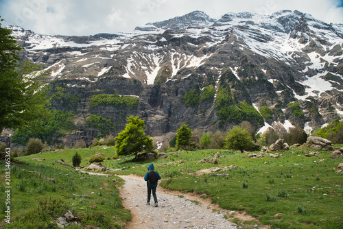 A young girl hiking alone in the Pyrenees, Pineta Valley, Monte Perdido, Camino de los Llanos de la Larri, Aragón, Huesca, Spain