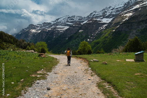 A young girl hiking alone in the Pyrenees, Pineta Valley, Monte Perdido, Camino de los Llanos de la Larri, Aragón, Huesca, Spain
