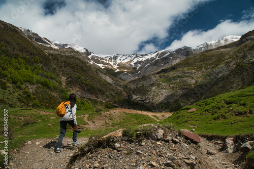 A young girl hiking alone in the Pyrenees, Pineta Valley, Monte Perdido, Camino de los Llanos de la Larri, Aragón, Huesca, Spain