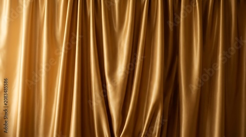 Luxurious Golden Silk Fabric Background with Smooth Flowing Folds, Elegant Shiny Satin Texture for Premium Luxury Design.