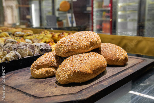 Konstfotografi Artisian multigrain bread on wooden board in traditional Argentine bakery
