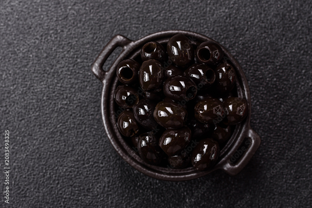 Obraz premium Black canned olives without pits for salads and snacks. Black olives without pits