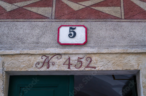 Two House Numbers Above Door
