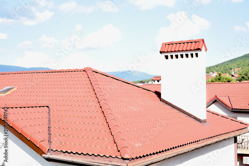 View of rooftops made of ceramic tiles in the mountains
