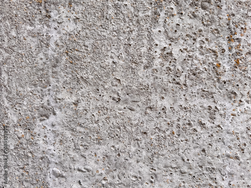 Obraz premium Rough gray concrete surface texture with porous holes and weathered patterns background