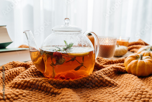 Картината върху платно Herbal tea brewing in teapot on cozy autumn blanket