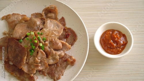 Fried chicken pieces with spicy dipping sauce on a plate