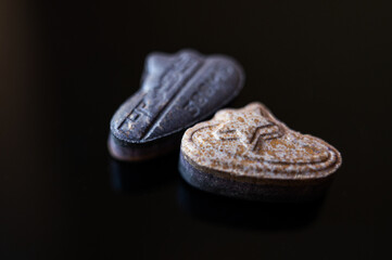 MDMA ecstasy pills shaped like designer logos on a black reflective background, 300mg Pop Smoke theme conceptual close-up
