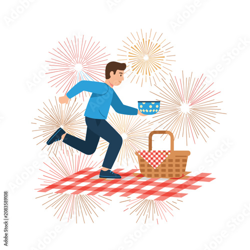 Man running on picnic blanket with basket and fireworks