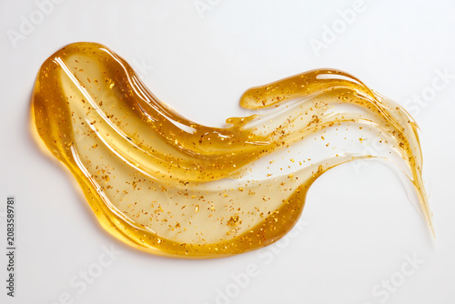Premium gold skincare gel texture isolated on white