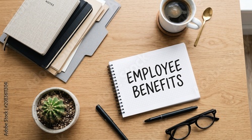 Office desk with employee benefits notebook and supplies