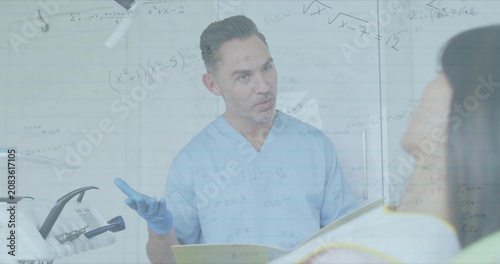 Opening yellow folder, clinician speaking and gesturing while checking chart, explaining treatment