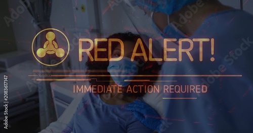 Obraz na plátně Nurse touching patient's shoulder at bedside, HUD appearing and escalating RED A
