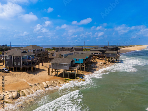 Принти на полотні Homes on stilts in danger of being destroyed by ocean waves in Buxton North Caro