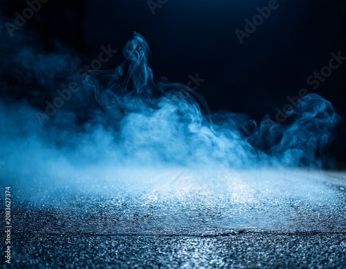 extreme close up of blue smoke and fog on asphalt with black defocused background