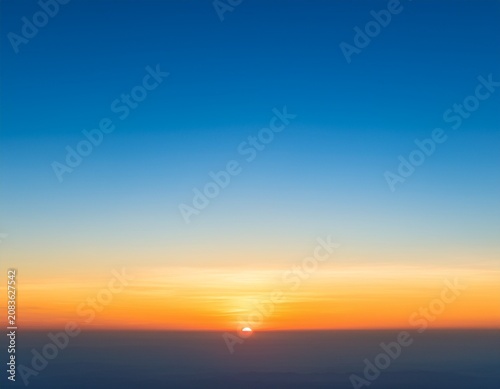 abstract gradient sunrise in the sky with blue and orange natural background