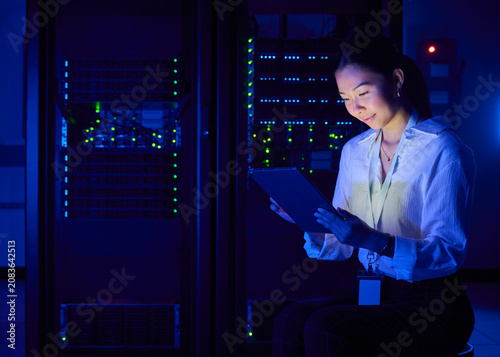 Asian Female Cybersecurity Professional Working in Data Center