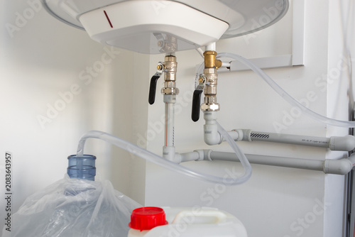 Konstfotografi Water heater connected to the water supply via a pipe