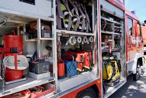Fire truck with open equipment compartments and emergency number marking