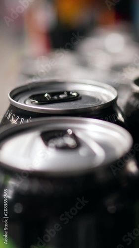 From top-down perspective store shelf is filled with rows of metal cans, alternating beer and sparkling soda labels, cans are tightly packed for efficient retail display and easy inventory handling