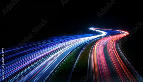 abstract long exposure of colorful light trails from fast moving vehicles on a dark highway curve concept for speed delivery service technology innovation and modern transportation