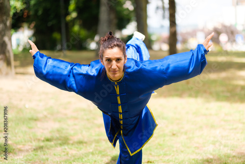 Fotografía Woman practicing kung fu balance pose outdoors